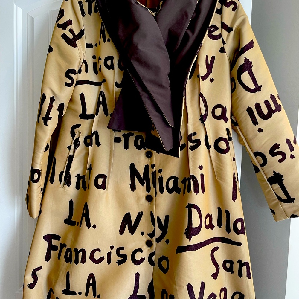 Tan and brown coat with names Vegas, New York, LA, Dallas, San Francisco, on.